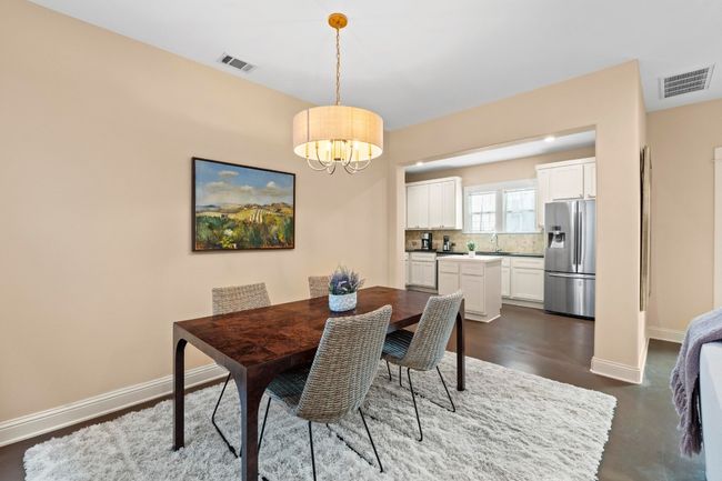 Dining area flows into the well-organized kitchen. | Image 15