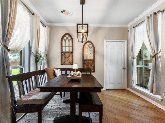 Dining room featuring light wood-style floors and crown molding | Image 12