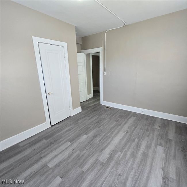 with visible vents, baseboards, and wood finished floors | Image 12