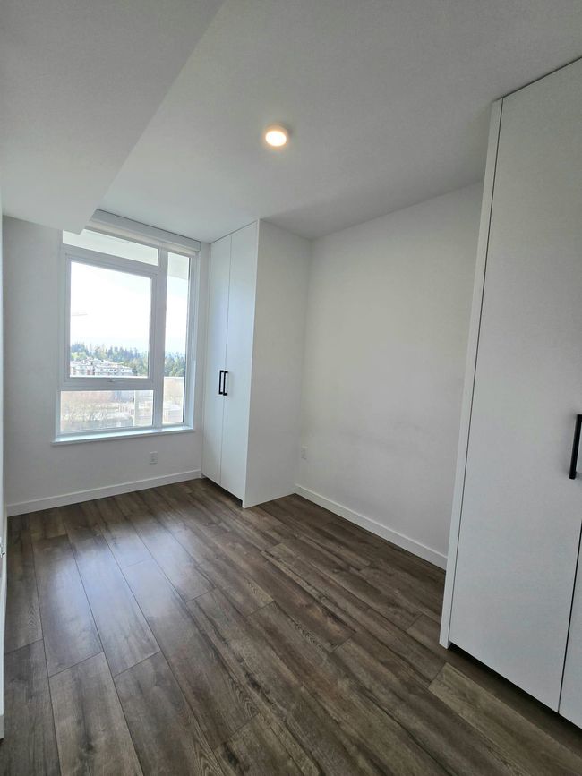 Spare room featuring baseboards and dark wood-style floors | Image 11