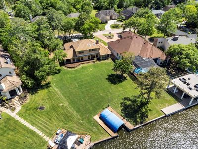 Experience serene lakefront living with expansive water views in April Sound. This property boasts a generous yard, perfect for recreational activities or creating your dream pool retreat. | Image 2