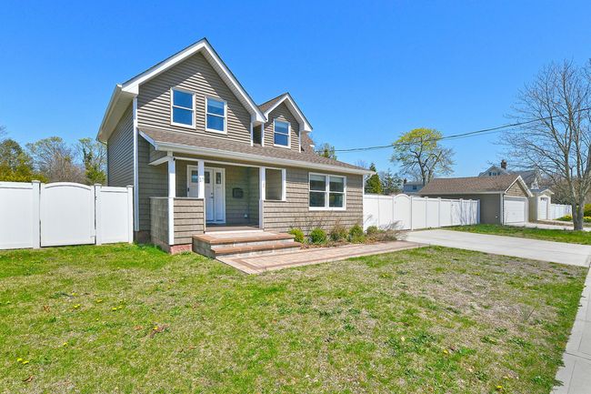 View of front of house with a gate, a front yard, covered porch, and fence | Image 4