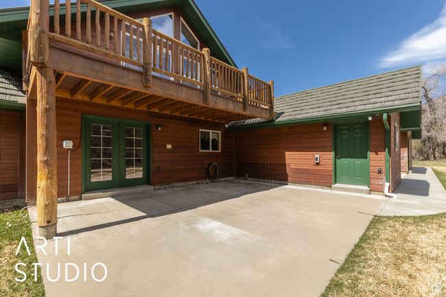 Rear view of property with roof with shingles, french doors, a wooden deck, and a patio area | Image 46