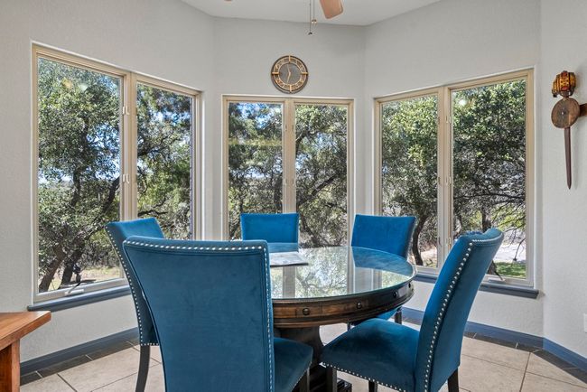 Sunroom / solarium featuring a ceiling fan | Image 13