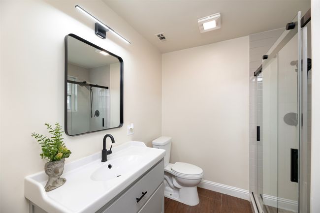 Full bathroom featuring toilet, a shower stall, vanity, and wood finished floors | Image 14