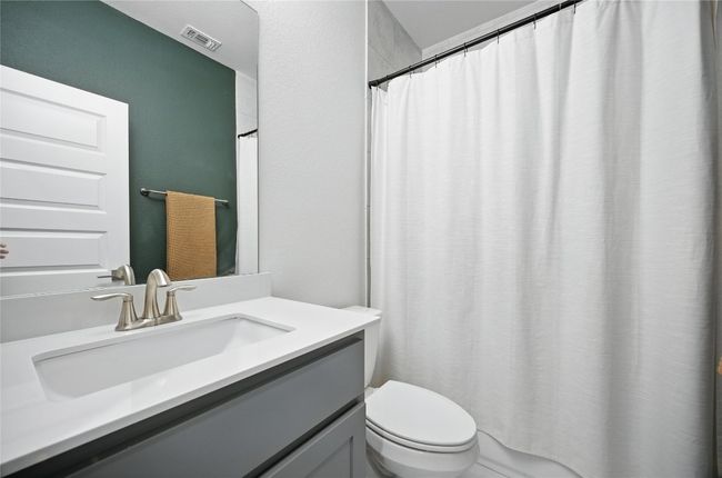 Upstairs Bathroom featuring vanity and curtained shower | Image 36