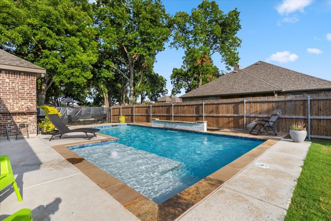 View of swimming pool featuring a patio area, a fenced backyard, and a fenced in pool | Image 32