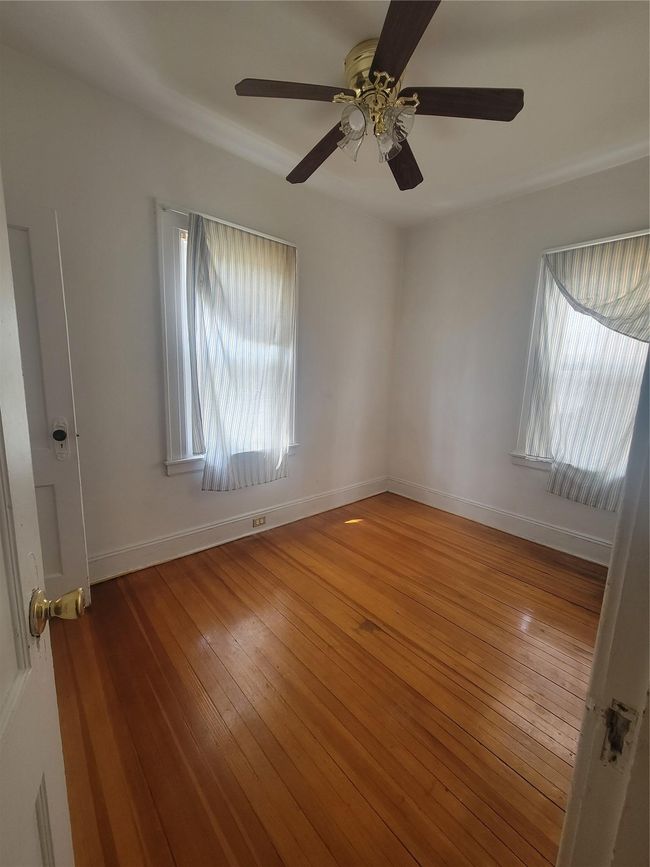 Empty room featuring baseboards, ceiling fan, and wood-type flooring | Image 7