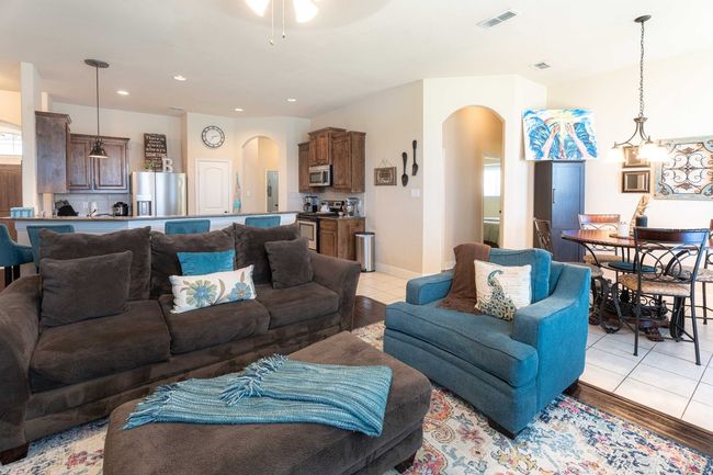 Living room featuring arched walkways, light tile patterned flooring, recessed lighting, and ceiling fan | Image 10