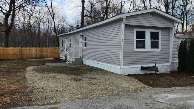 View of side of home with entry steps and fence | Image 32
