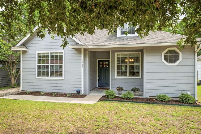 View of front facade featuring a front lawn and a shingled roof | Image 38
