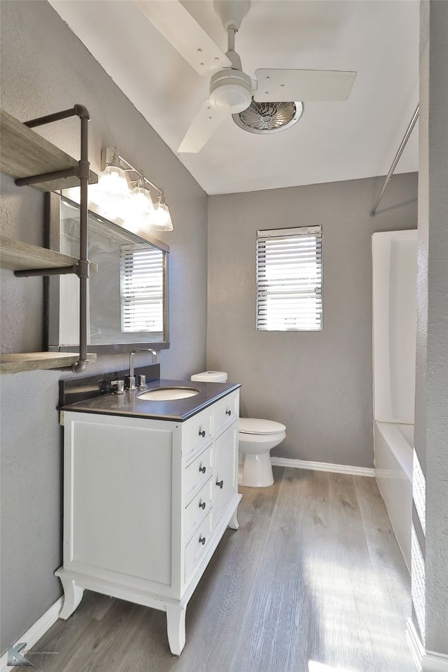 Bathroom with hardwood / wood-style flooring, vanity, a healthy amount of sunlight, and toilet | Image 17