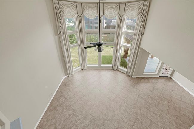 From the upper level, take in the dramatic architecture—double-height ceilings, sweeping windows, and an inviting view of the heart of the home. | Image 30