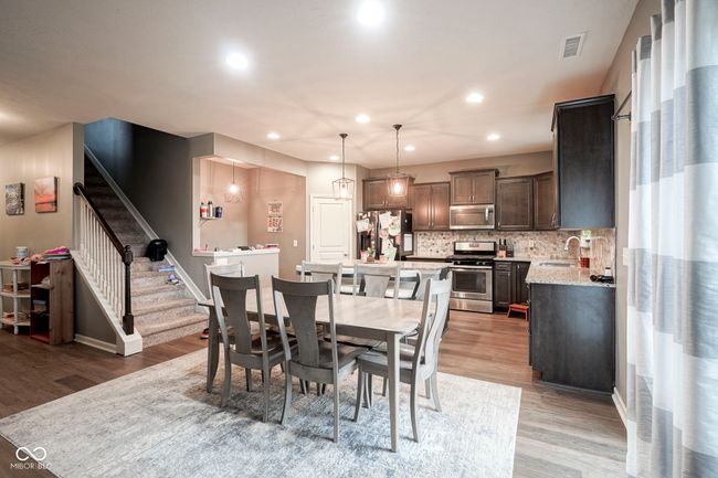 dining space with light wood-style flooring, stairs, recessed lighting, and baseboards | Image 16