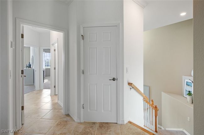 Hall with an upstairs landing, baseboards, and light tile patterned floors | Image 36
