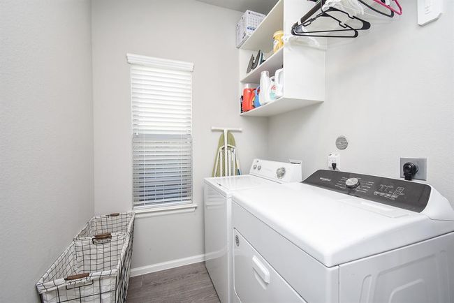 Big utility room has a space to the right of washer for a refrigerator or freezer | Image 28