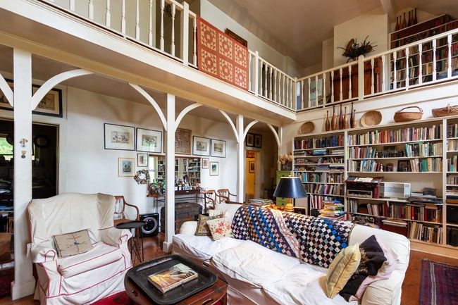 Living room featuring a high ceiling and arched walkways | Image 7