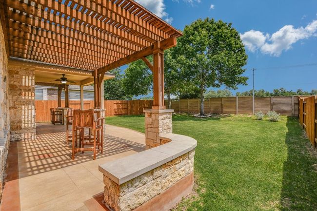 View of yard featuring ceiling fan, a patio, and a pergola | Image 28