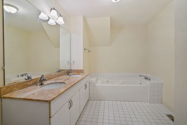 Primary bathroom with jetted tub, double vanity and stall shower | Image 18