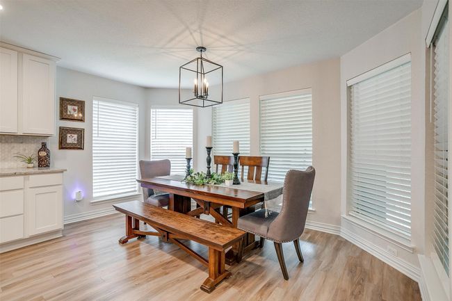 Dining area featuring a chandelier and light wood-type flooring | Image 12