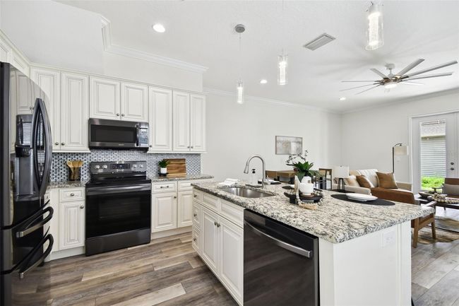 Kitchen opens up to dining & living rooms | Image 9