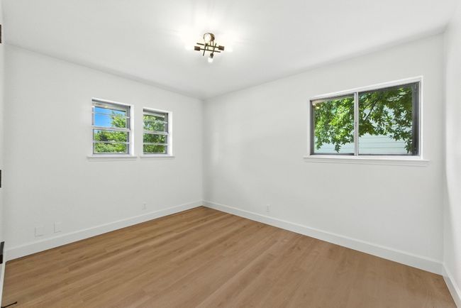 Spare room featuring baseboards and light wood finished floors | Image 19