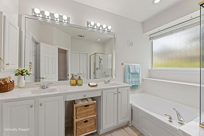 Full bathroom with a stall shower, a garden tub, double vanity, tile patterned flooring, and recessed lighting | Image 28
