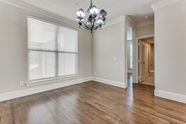 Unfurnished room with a chandelier, ornamental molding, and wood finished floors | Image 8