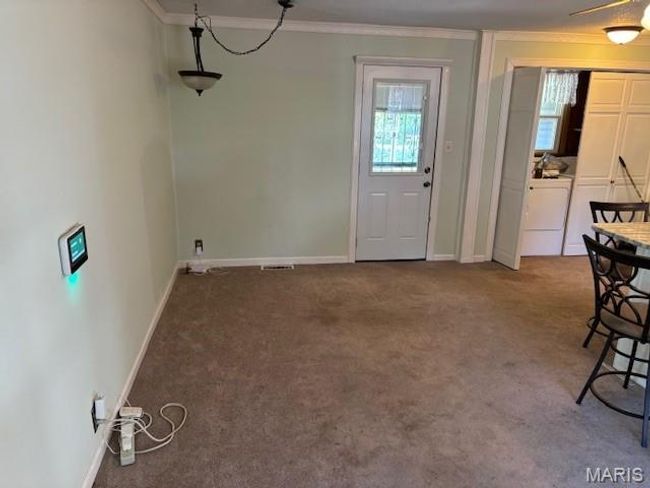 Unfurnished dining area with ornamental molding, carpet flooring, and baseboards | Image 17