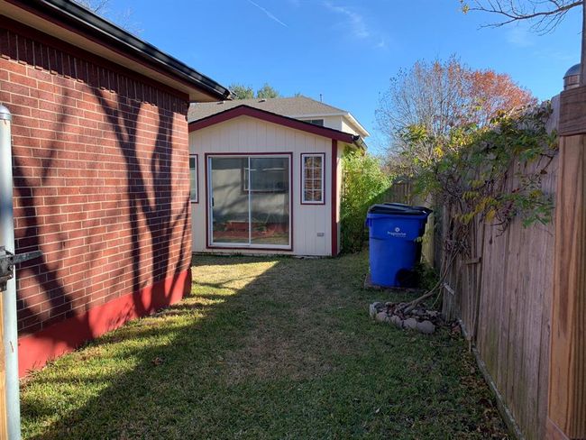 Storage shed designed to match home with same roof and gutters. | Image 4