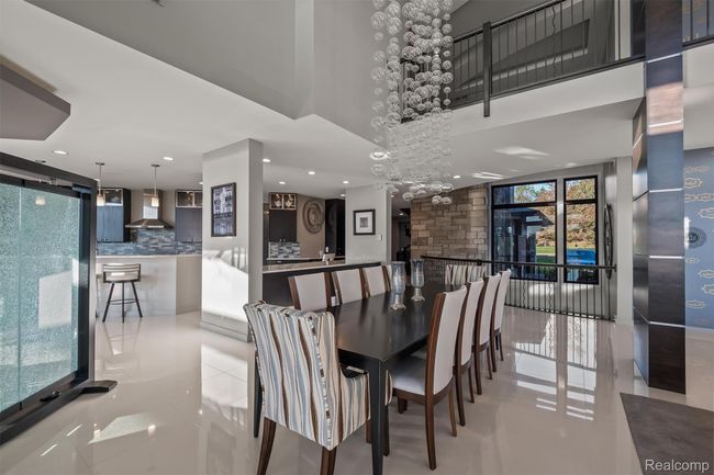 Dining space featuring light tile patterned flooring, a chandelier, and recessed lighting | Image 42