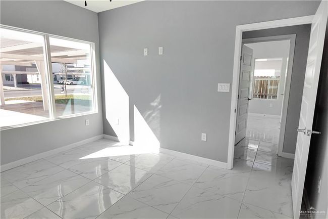 Empty room with marble finish floor and baseboards | Image 15