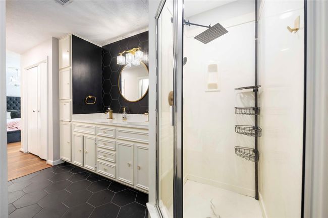 The primary bathroom has a separate, but spacious enclosed shower, right beside the bath tub. | Image 30
