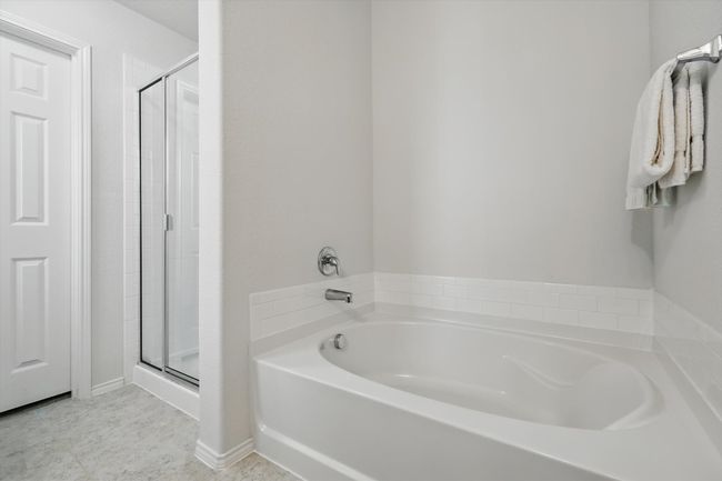 Bathroom featuring a garden tub and a stall shower | Image 33