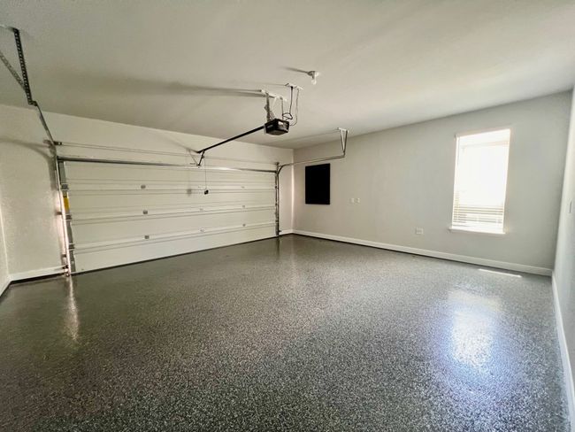 Garage with a garage door opener and baseboards | Image 24