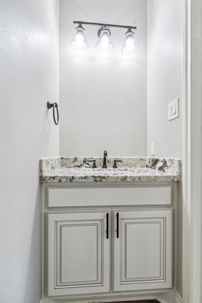 The secondary upstairs bedrooms each boast a dedicated sink area, with the closets smartly integrated into these spaces. | Image 33