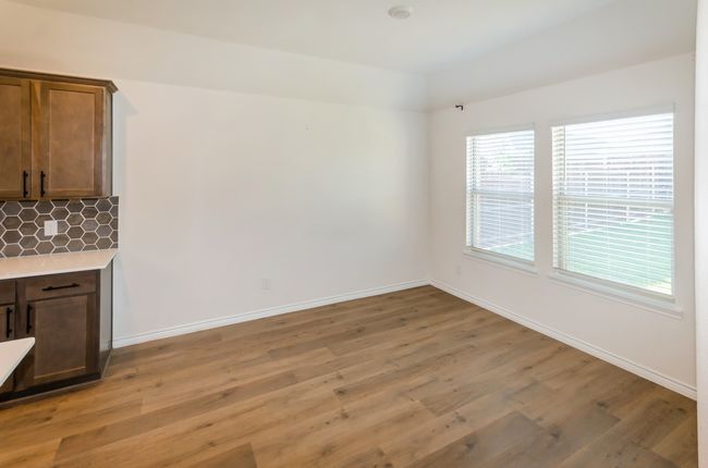 Unfurnished dining area with light wood-style flooring and baseboards | Image 21