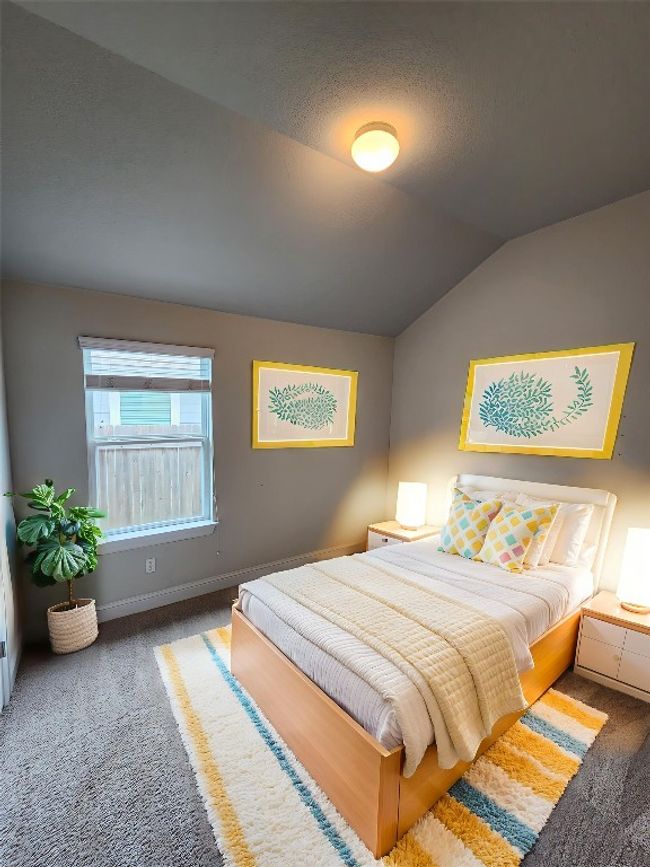 Carpeted bedroom with vaulted ceiling and baseboards | Image 21
