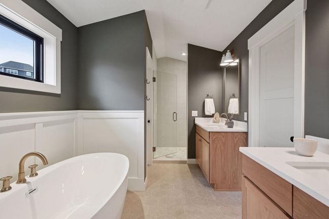 Private, luxury owner's bathroom with privatized toilet, a walk-in closet, and separate sinks. | Image 12
