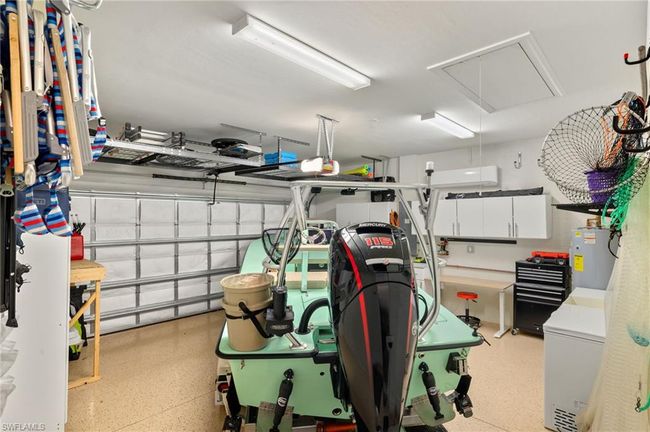 Garage featuring water heater and refrigerator | Image 30