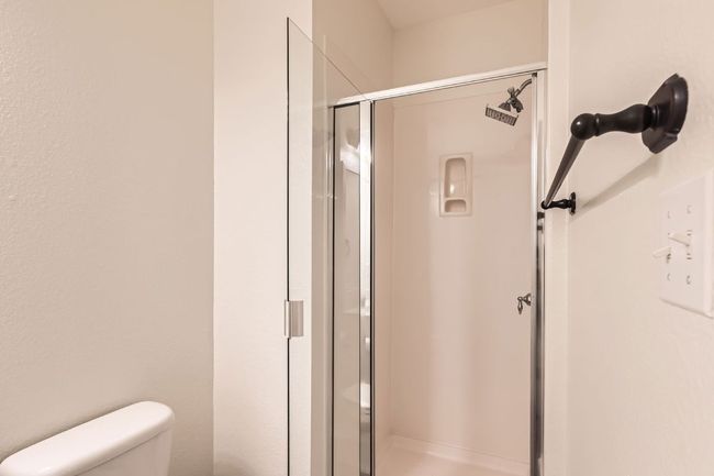 Full bath featuring a stall shower and toilet | Image 18
