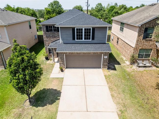 Gray tones combined with brown brick facade create a modern yet warm and inviting exterior appeal. | Image 8