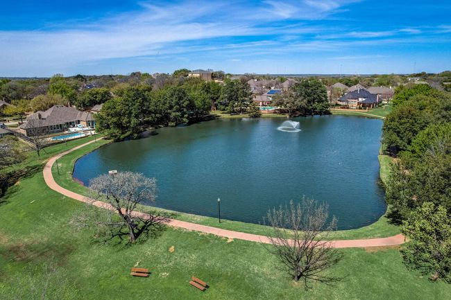 Private community pond with waterfall features, walking path, and playground | Image 35