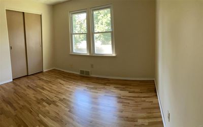 Unfurnished bedroom featuring a closet and light hardwood / wood-style floors | Image 3