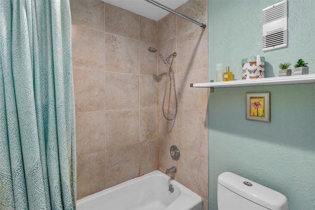 Full tile shower and tub with seafoam walls | Image 16