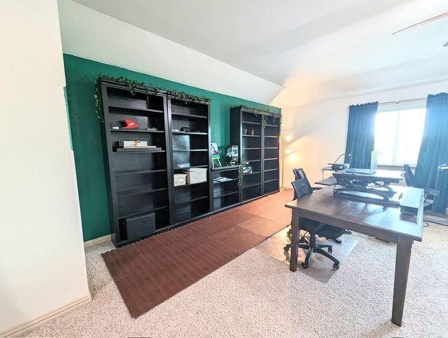 Carpeted office space with vaulted ceiling and baseboards | Image 6