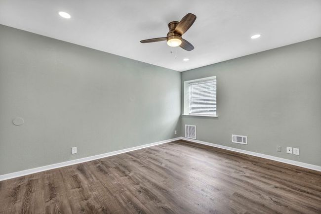 Spare room featuring dark wood finished floors, ceiling fan, baseboards, and recessed lighting | Image 10