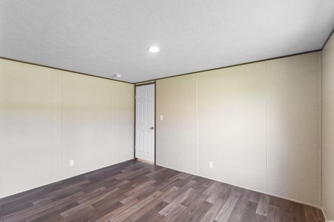 Unfurnished room featuring wood finished floors, a textured ceiling, and recessed lighting | Image 22