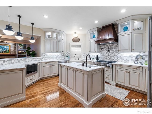 Modern Chefs Kitchen with Two Sinks, Dual Ovens, Gas Range, and Stainless Steel Appliances. | Image 12