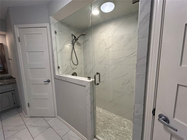 Bathroom with marble finish flooring, a shower stall, and vanity | Image 25